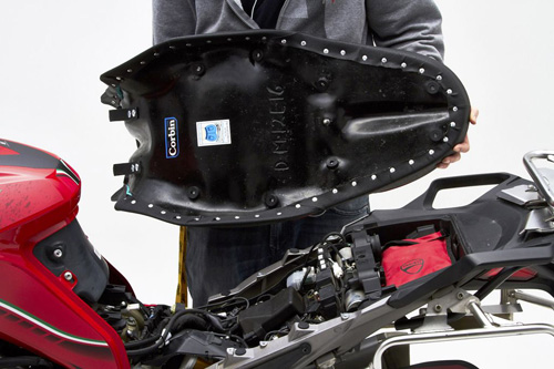 a person holding Dual seat showing the back side, MPN printed and mounting brackets pre-installed