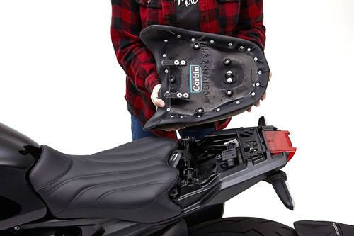 a person holding Rear seat showing the back side, MPN printed and mounting brackets pre-installed