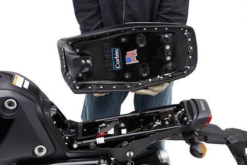 a person holding Dual seat showing the back side, MPN printed and mounting brackets pre-installed