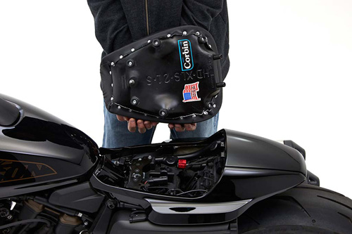 a person holding Front seat showing the back side, MPN printed and mounting brackets pre-installed