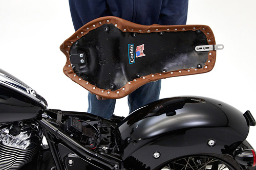 a person holding Gambler seat showing the back side, MPN printed and mounting brackets pre-installed