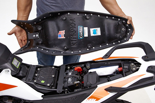 a person holding Rally seat showing the back side, MPN printed and mounting brackets pre-installed