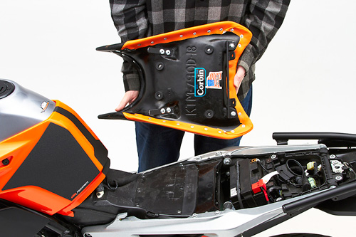 a person holding Front seat showing the back side, MPN printed and mounting brackets pre-installed