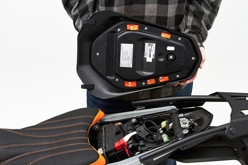 a person holding Rear seat showing the back side, MPN printed and mounting brackets pre-installed