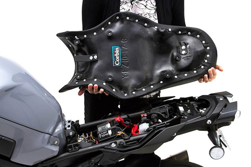 a person holding Gunfighter seat showing the back side, MPN printed and mounting brackets pre-installed