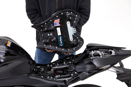 a person holding Front seat showing the back side, MPN printed and mounting brackets pre-installed