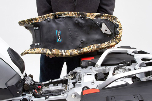 a person holding Front & Rear seat showing the back side, MPN printed and mounting brackets pre-installed
