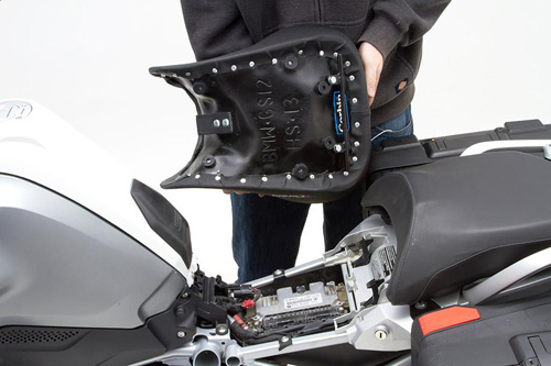 a person holding Front seat showing the back side, MPN printed and mounting brackets pre-installed