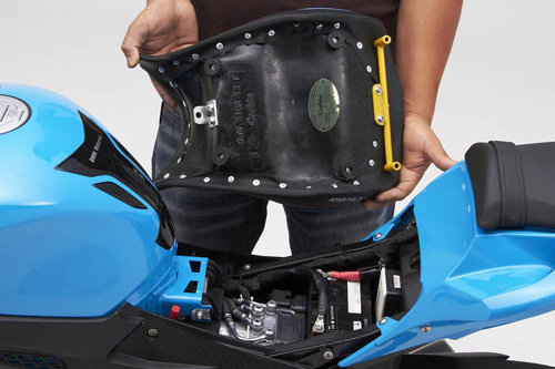 a person holding Front seat showing the back side, MPN printed and mounting brackets pre-installed