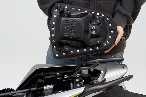 a person holding Rear seat showing the back side, MPN printed and mounting brackets pre-installed