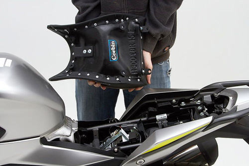 a person holding Front seat showing the back side, MPN printed and mounting brackets pre-installed