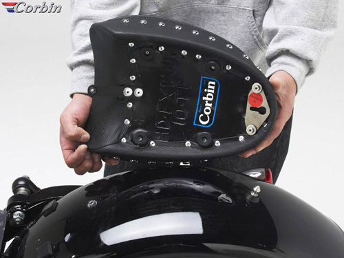 a person holding Pillion Pad showing the back side, MPN printed and mounting brackets pre-installed