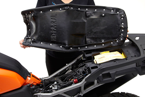 a person holding Rally seat showing the back side, MPN printed and mounting brackets pre-installed