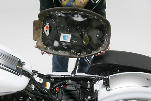 a person holding Front seat showing the back side heater wiring, MPN printed and mounting brackets pre-installed