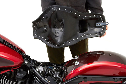 a person holding Gambler seat showing the back side, MPN printed and mounting brackets pre-installed