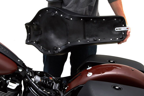 a person holding Widowmaker seat showing the back side, MPN printed and mounting brackets pre-installed