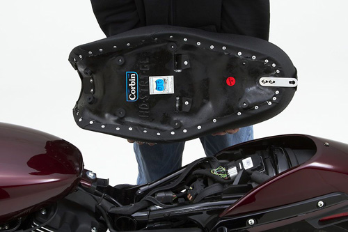 a person holding Gunfighter & Lady seat showing the back side, MPN printed and mounting brackets pre-installed