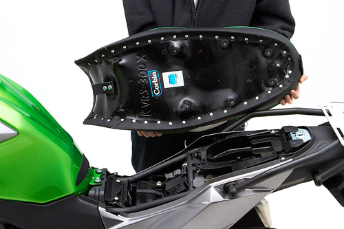 a person holding Canyon Dual Sport seat showing the back side, MPN printed and mounting brackets pre-installed