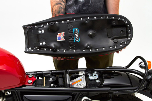 a person holding Gunfighter seat showing the back side, MPN printed and mounting brackets pre-installed