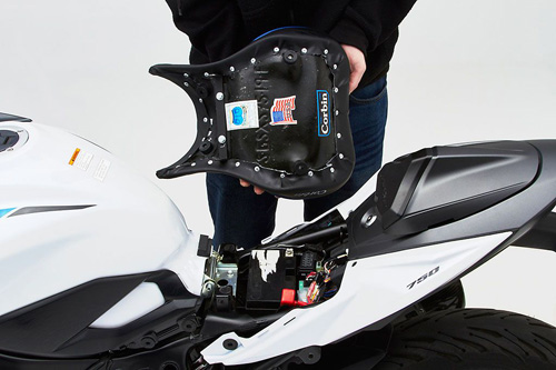 a person holding Front seat showing the back side, MPN printed and mounting brackets pre-installed