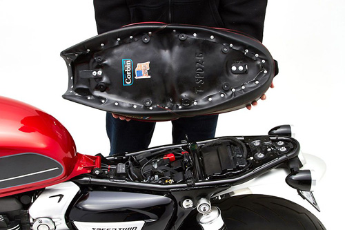 a person holding Gunfighter seat showing the back side, MPN printed and mounting brackets pre-installed