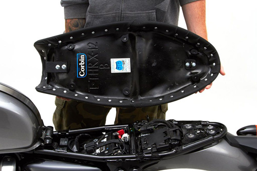 a person holding Gunfighter seat showing the back side, MPN printed and mounting brackets pre-installed