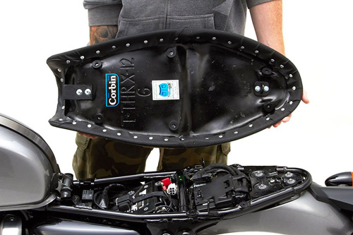 a person holding Gunfighter seat showing the back side, MPN printed and mounting brackets pre-installed