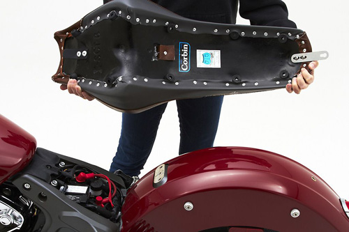 a person holding Brave seat showing the back side, MPN printed and mounting brackets pre-installed