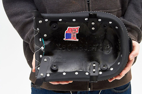 a person holding a Pillion seat showing the rear side with a sticker of american flag