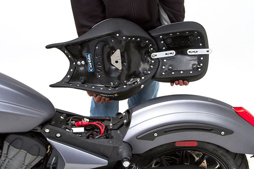 a person holding Front & Rear seat showing the back side, MPN printed and mounting brackets pre-installed