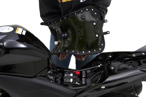 a person holding Front seat showing the back side, MPN printed and mounting brackets pre-installed