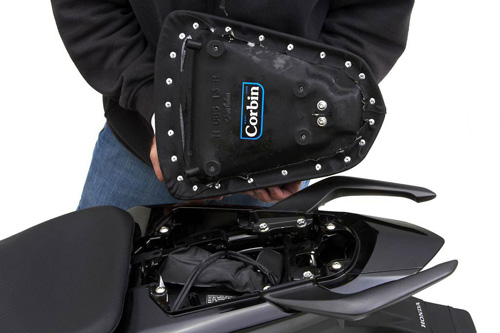 a person holding Rear seat showing the back side, MPN printed and mounting brackets(latch hooks) pre-installed