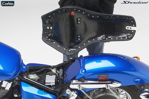 a person holding Young Guns seat showing the back side, MPN printed and mounting brackets pre-installed
