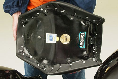 a person holding Front seat showing the back side mounting brackets pre-installed