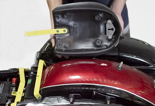 a person holding Rear seat showing the back side, MPN printed and mounting brackets pre-installed