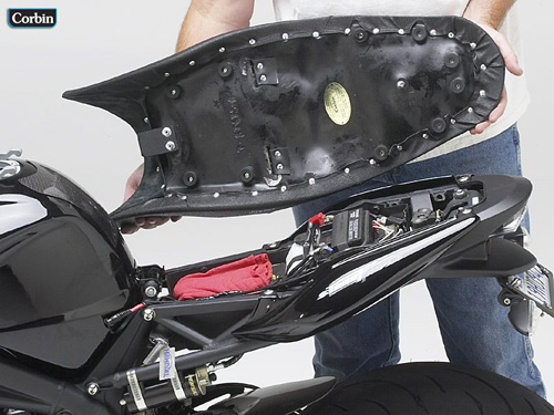 a person holding Dual seat showing the back side, MPN printed and mounting brackets pre-installed