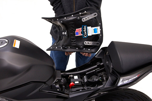 a person holding Front seat showing the rear side, MPN printed and mounting brackets pre-installed