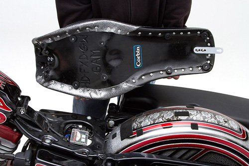 a person holding Widowmaker seat showing the rear side, MPN printed and mounting brackets pre-installed