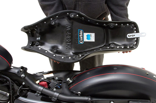 a person holding Widowmaker seat showing the rear side, MPN printed and mounting brackets pre-installed