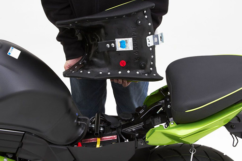 a person holding Front seat showing the back side, MPN printed and mounting brackets pre-installed