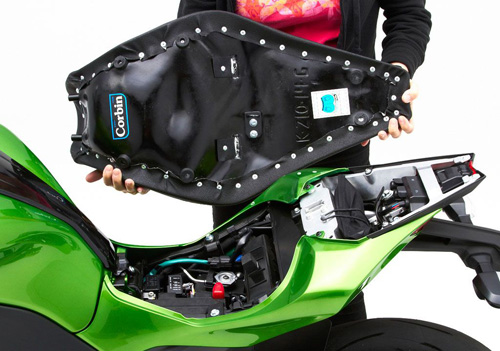 a person holding Gunfighter seat showing the back side, MPN printed and mounting brackets pre-installed