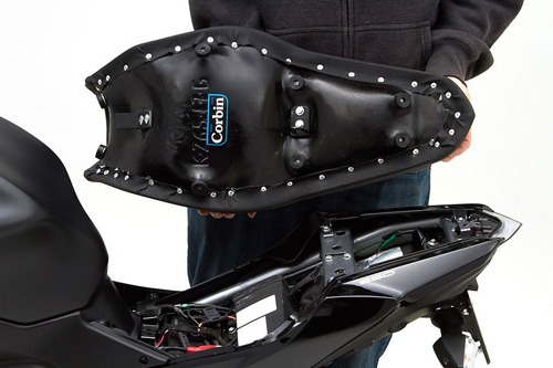 a person holding Gunfighter seat showing the back side, MPN printed and mounting brackets pre-installed