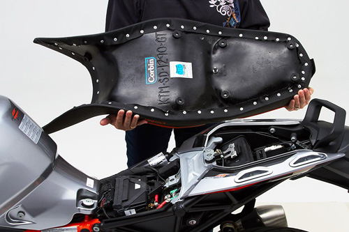 a person holding Dual seat showing the back side, MPN printed and mounting brackets pre-installed