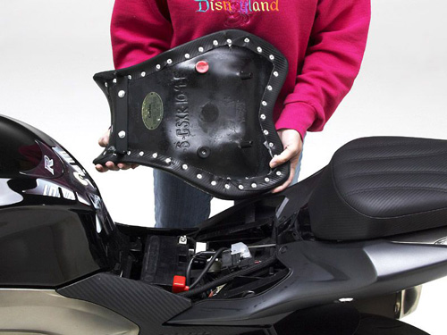 a person holding Front seat showing the rear side, MPN printed and mounting brackets pre-installed