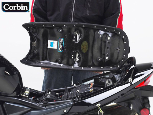 a person holding Gunfighter & Lady seat showing the rear side, MPN printed and mounting brackets pre-installed