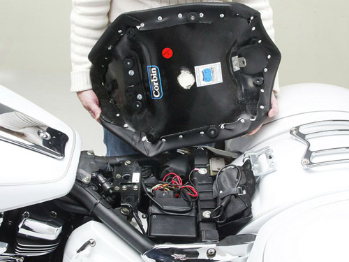 a person holding Hollywood Solo seat showing the rear side, MPN printed and mounting brackets pre-installed