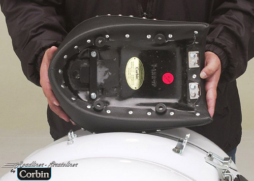 a person holding Rear seat showing the rear side, MPN printed and mounting brackets pre-installed