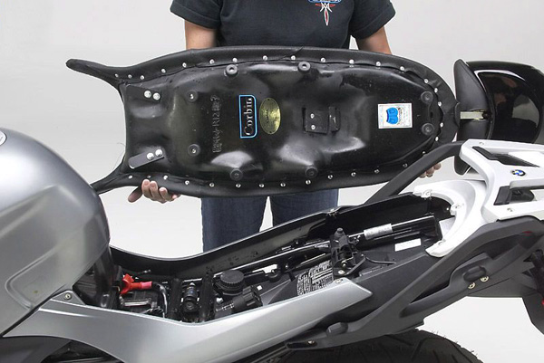 a person Canyon Dual Sport seat showing the rear side with MPN printed, mounting brackets pre-installed