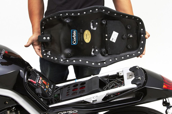 a person holding Gunfighter seat showing the rear sides with MPN printed and mounting brackets pre-installed