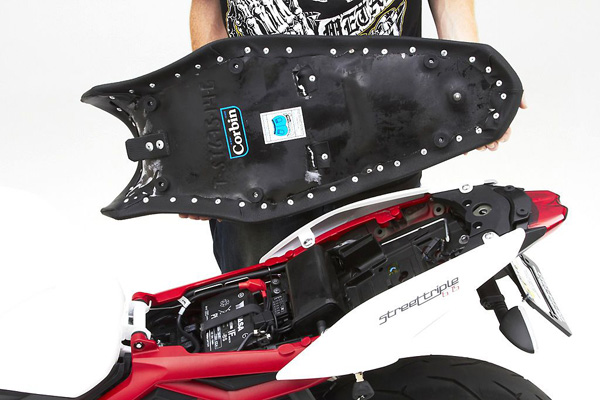 a person holding Gunfighter seat showing the rear side with MPN printed and mounting brackets pre-installed